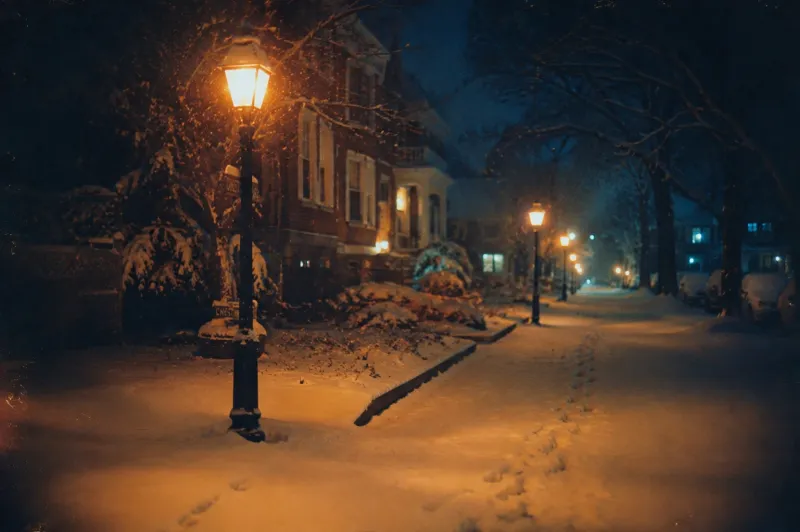 Snowfall Under Vintage Streetlights wallpaper preview
